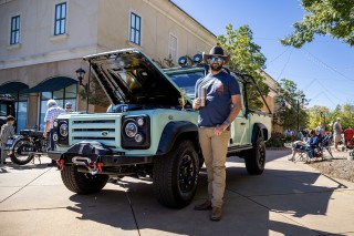 photo man stands beside vehicle